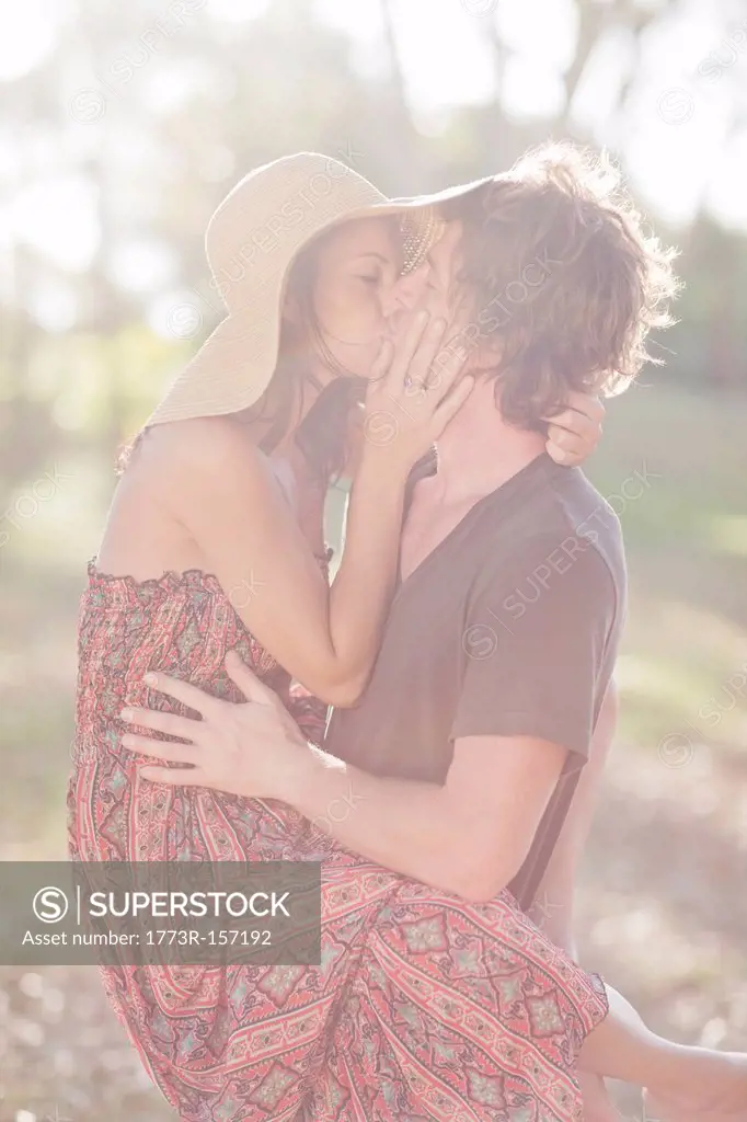 Couple kissing in field