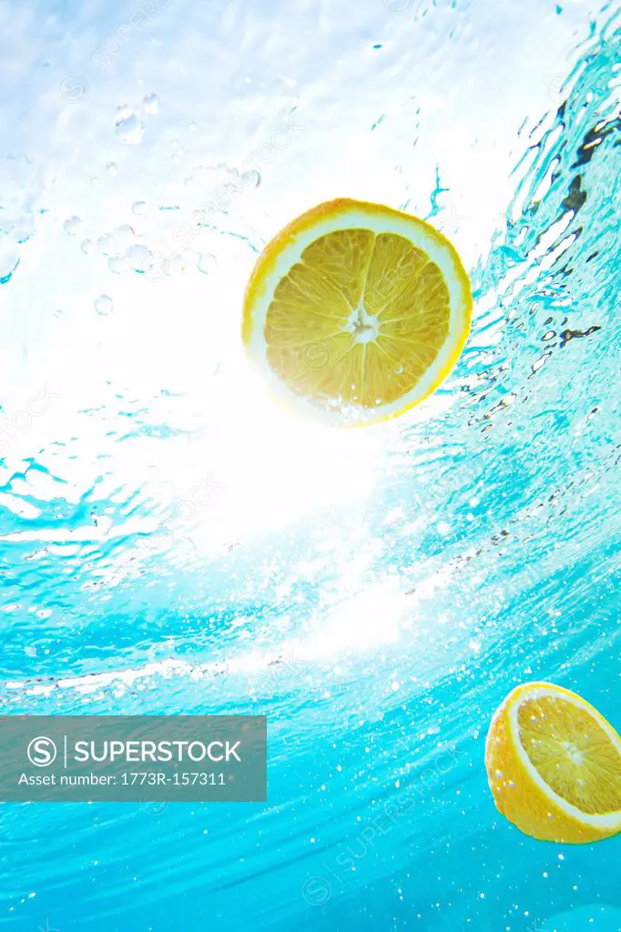Lemons floating in swimming pool