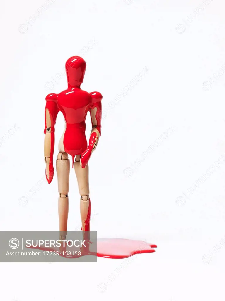 Wooden figurine splashed with paint