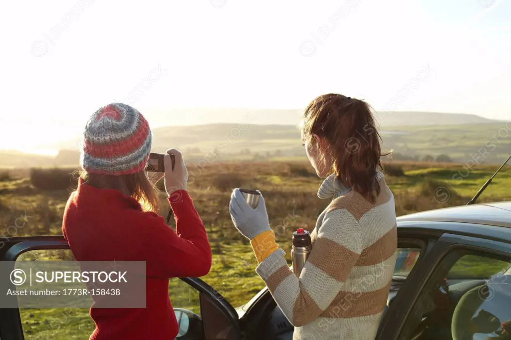 Women admiring landscape from car