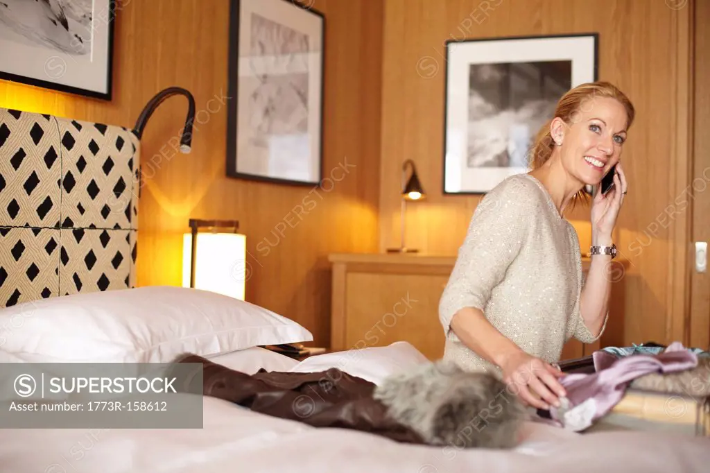 Woman on cell phone in hotel room