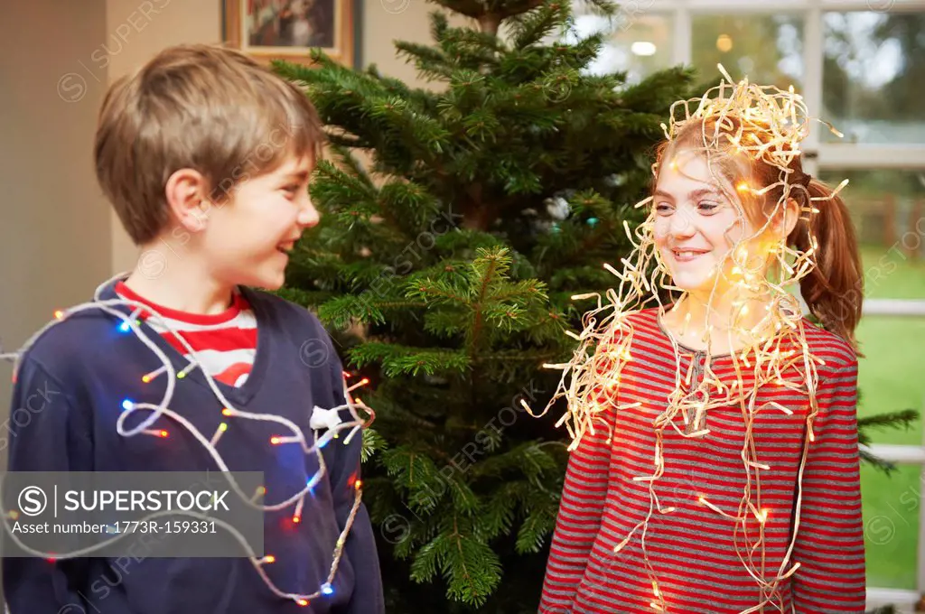 Children playing with Christmas lights