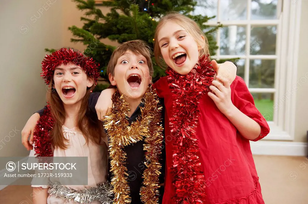Children playing with Christmas tinsel