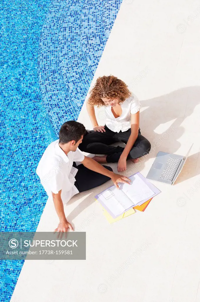 Business people working together by pool