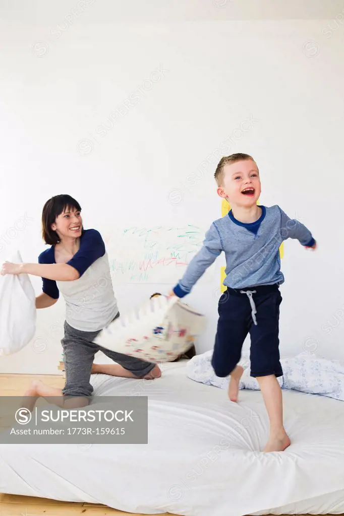 Mother and son having pillow fight