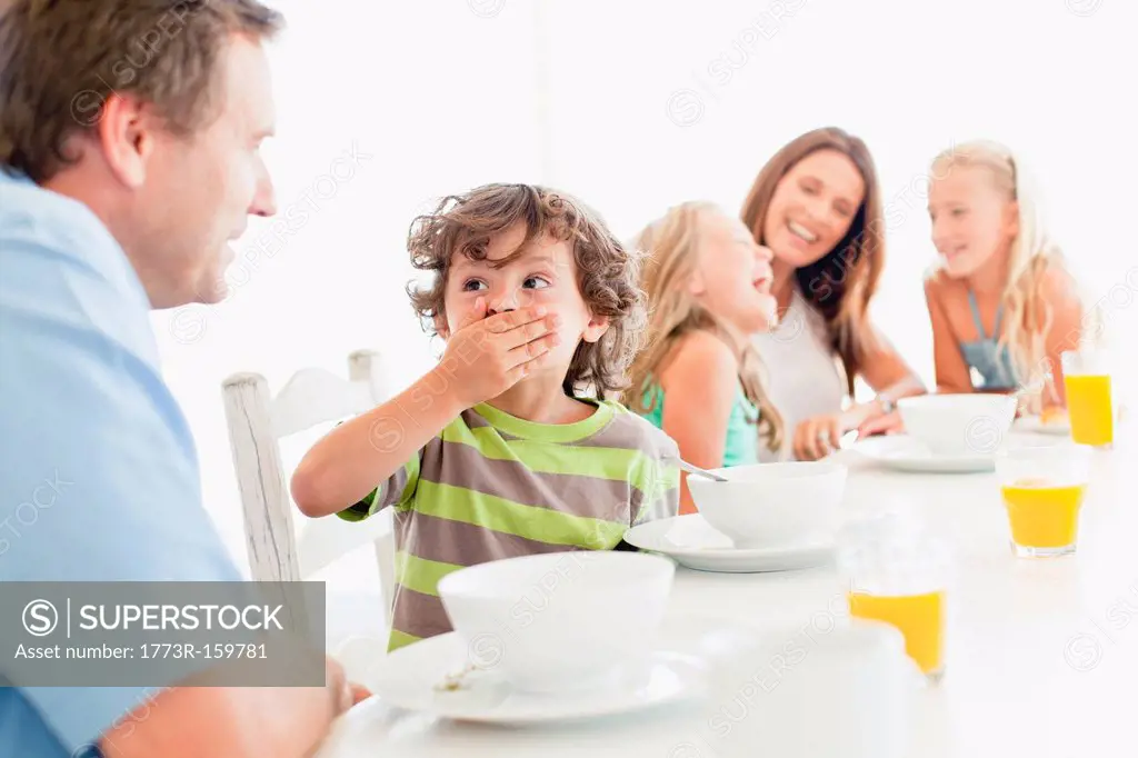 Family talking at breakfast table