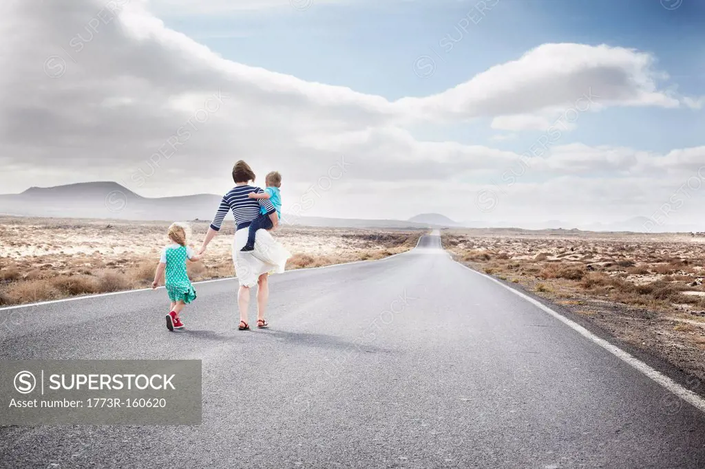 Family walking on paved rural road