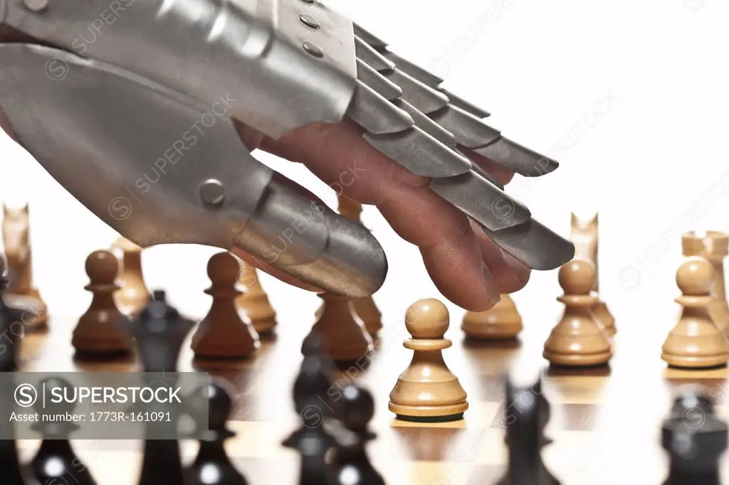 Close up of armored hand playing chess