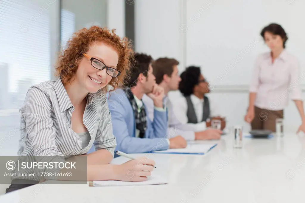 Businesswoman making notes in meeting