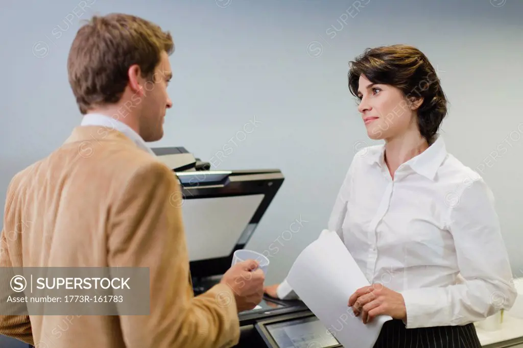 Business people talking at copier