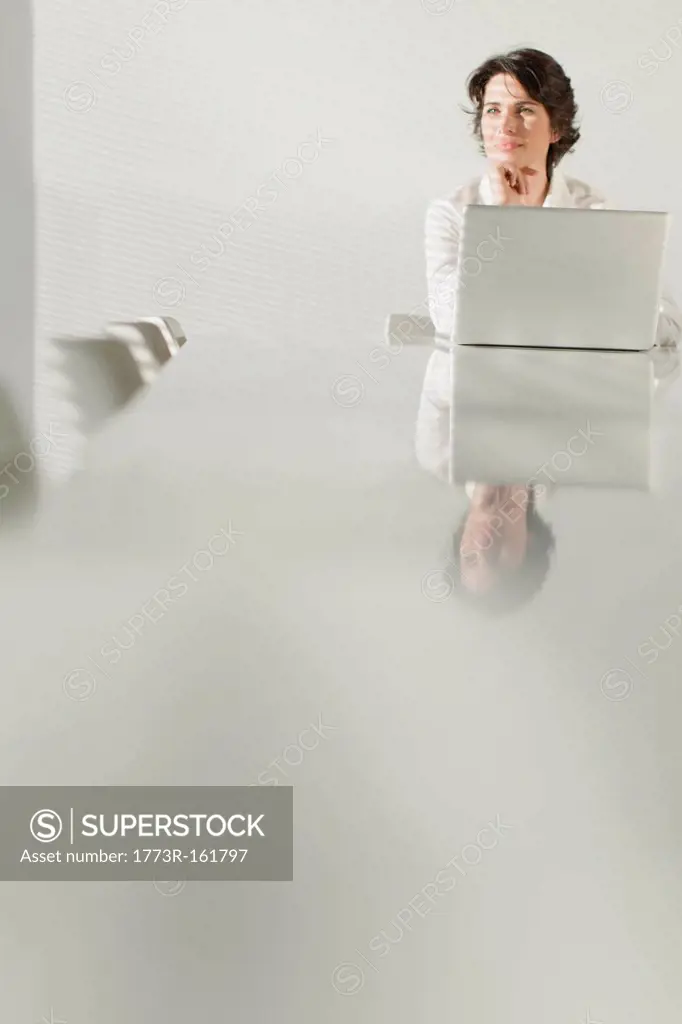 Businesswoman reflected in table