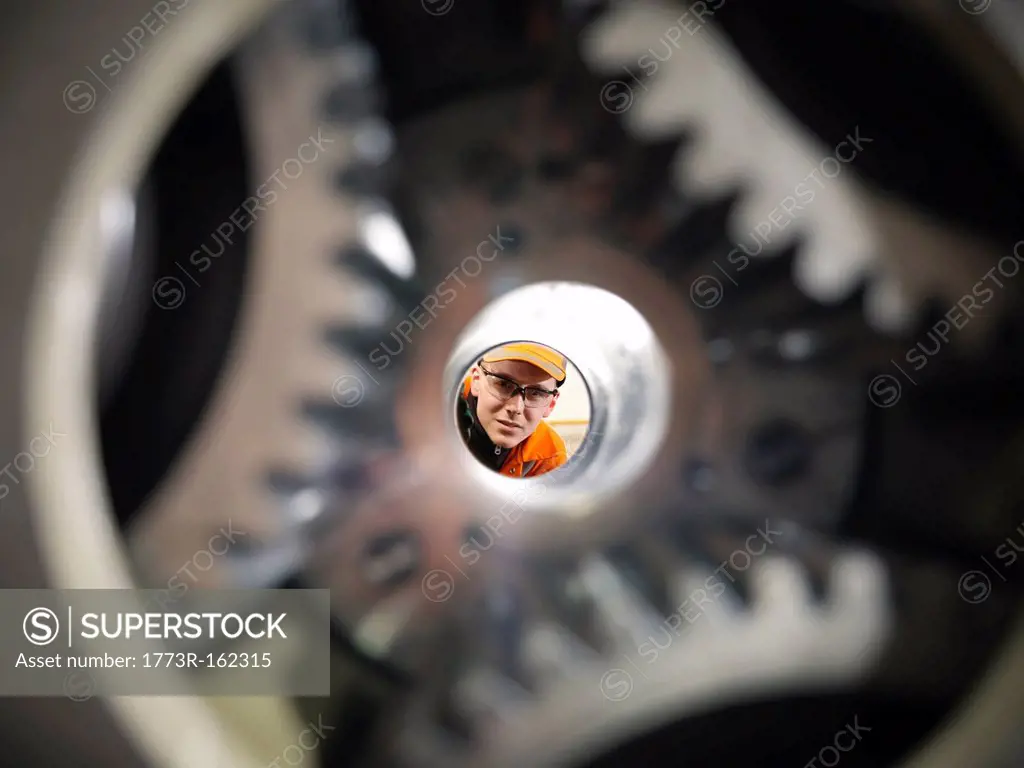 Apprentice engineer examining gears