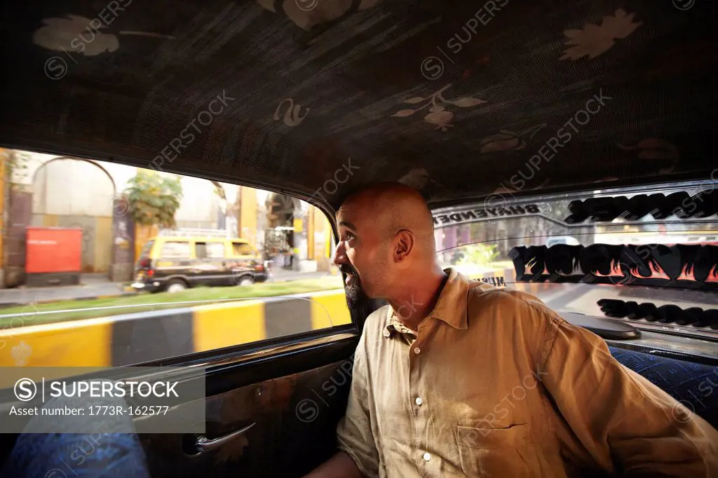 Smiling man riding in taxi cab