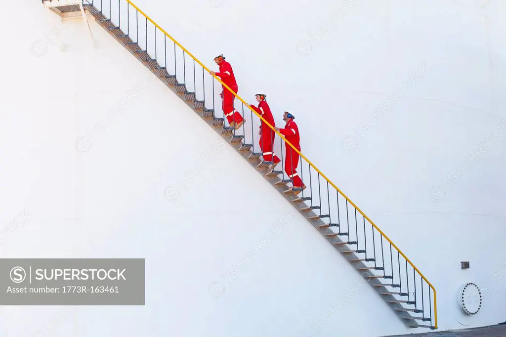 Workers on steps at chemical plant
