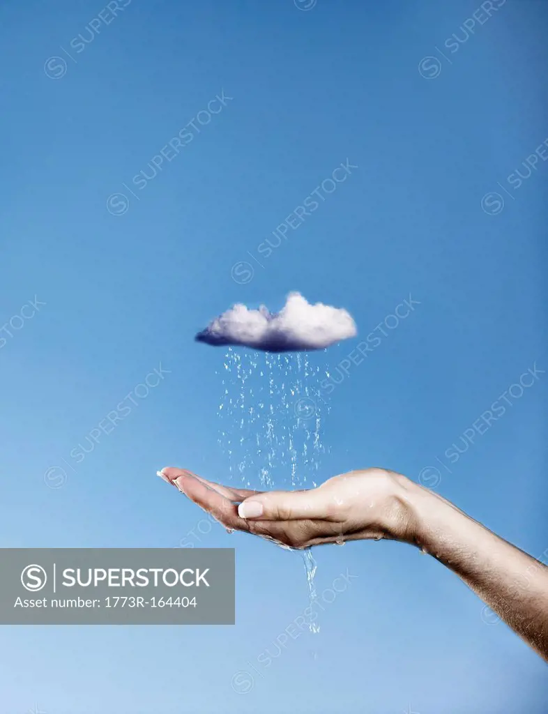 Hand holding pouring rain cloud