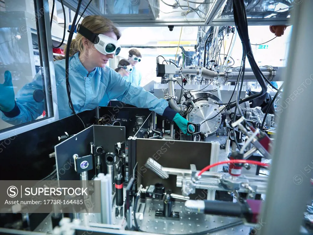 Scientist adjusting a mirror in lab