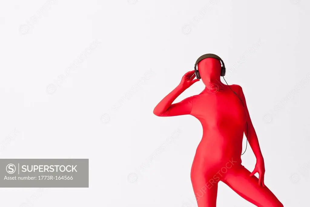 Woman in bodysuit wearing headphones