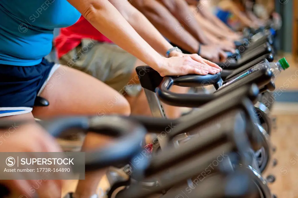 People using spin machines in gym