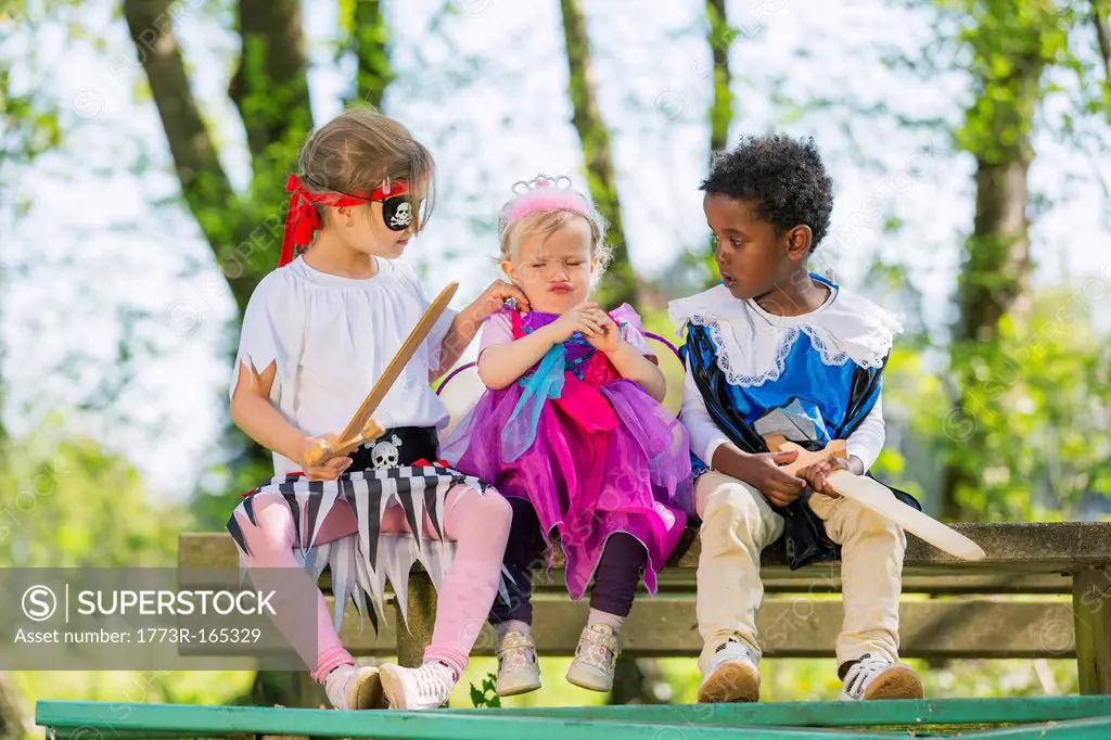 Children playing dress up outdoors