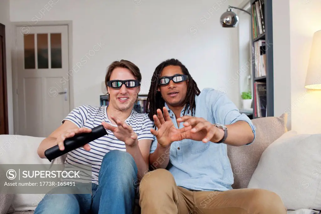 Men watching 3D television together