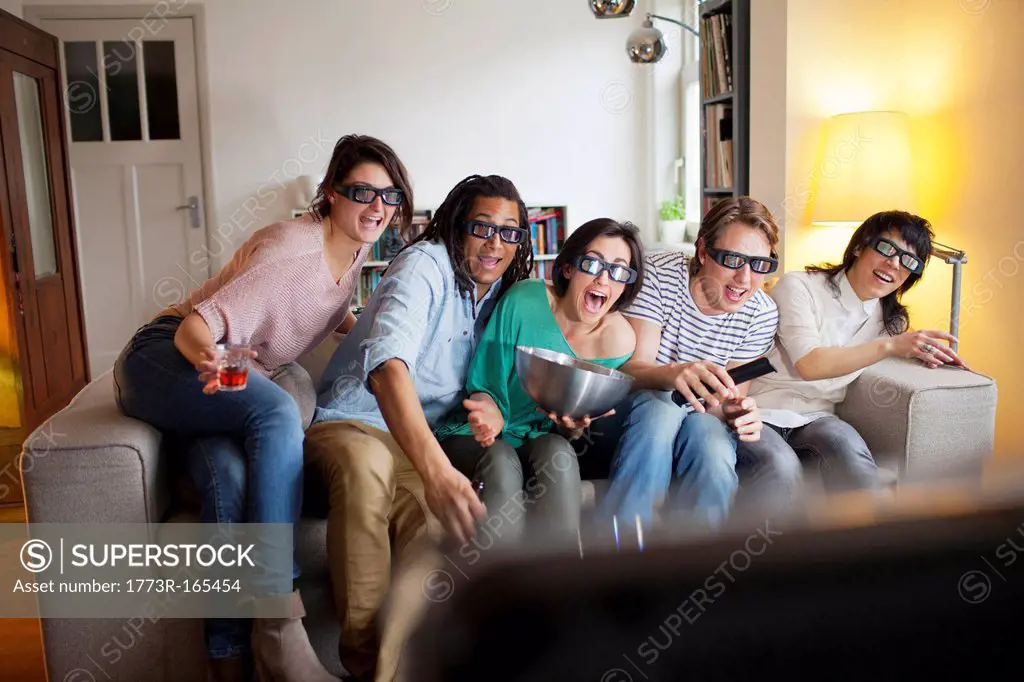 Friends watching 3D movie in living room