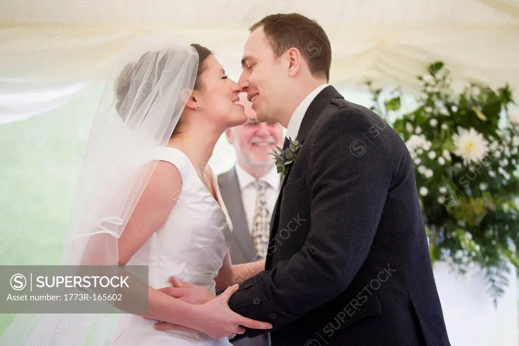 Newlywed couple kissing in wedding
