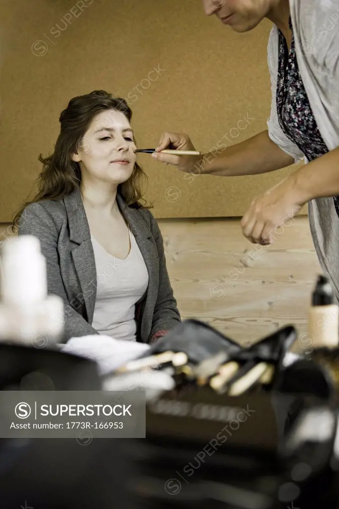 Make up artist working on client