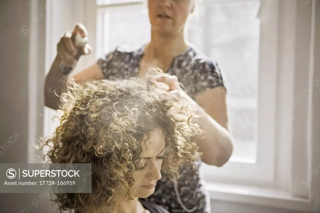 Hair stylist working on client