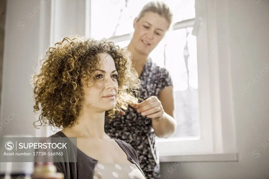 Hair stylist working on client