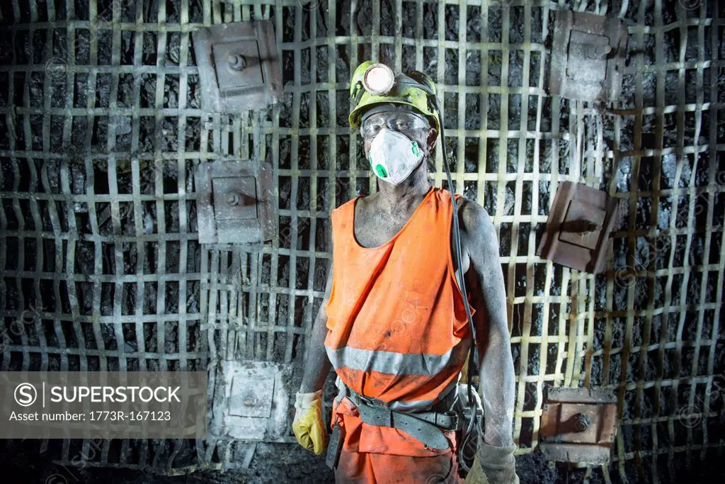 Coal miner standing in mine