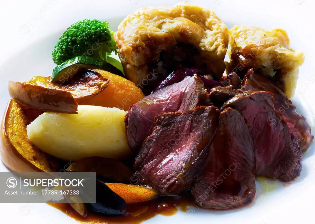 Plate of roast venison with beef pudding