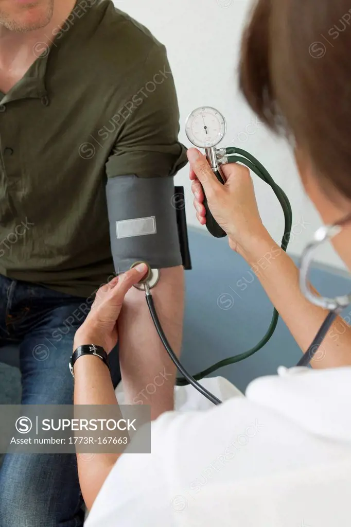 Doctor taking patients blood pressure