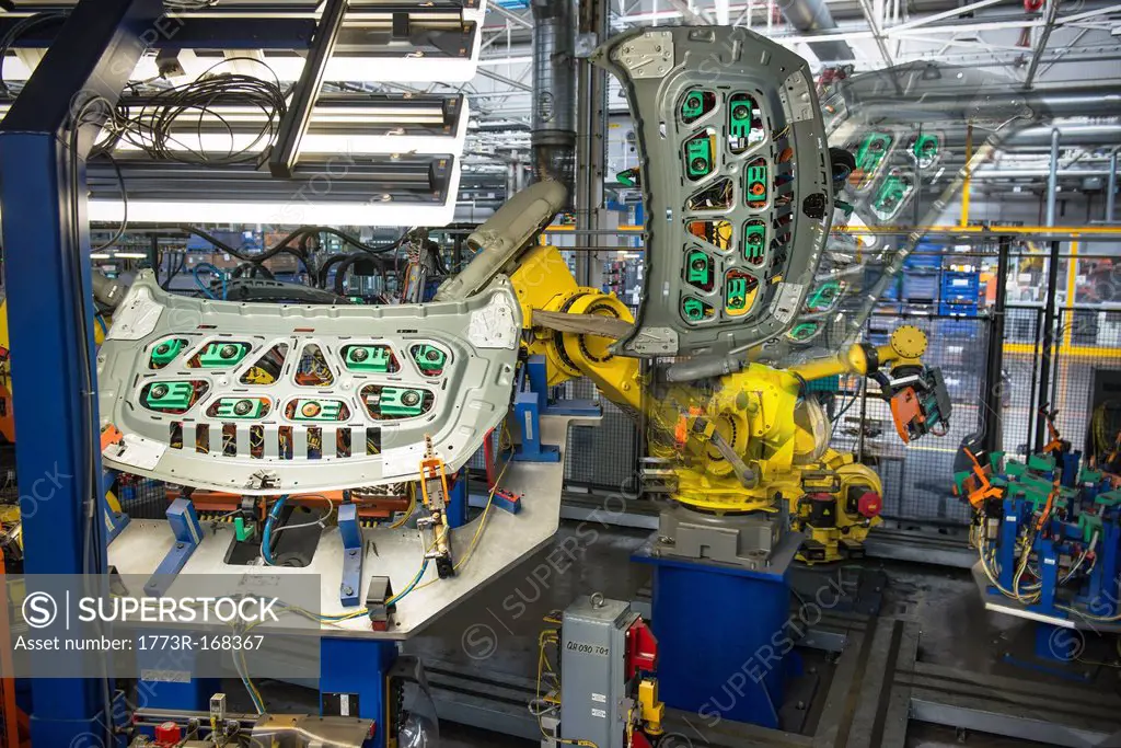 Robots handling car parts in car factory