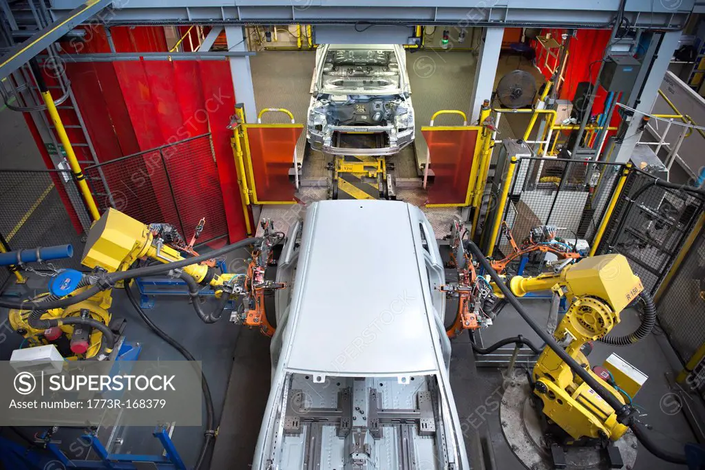 Car bodies on measuring machine in car factory