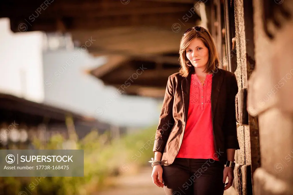 Smiling woman leaning against wall
