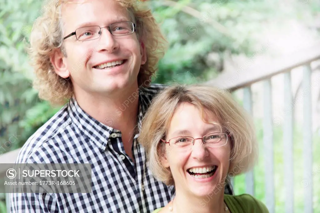 Smiling couple standing outdoors