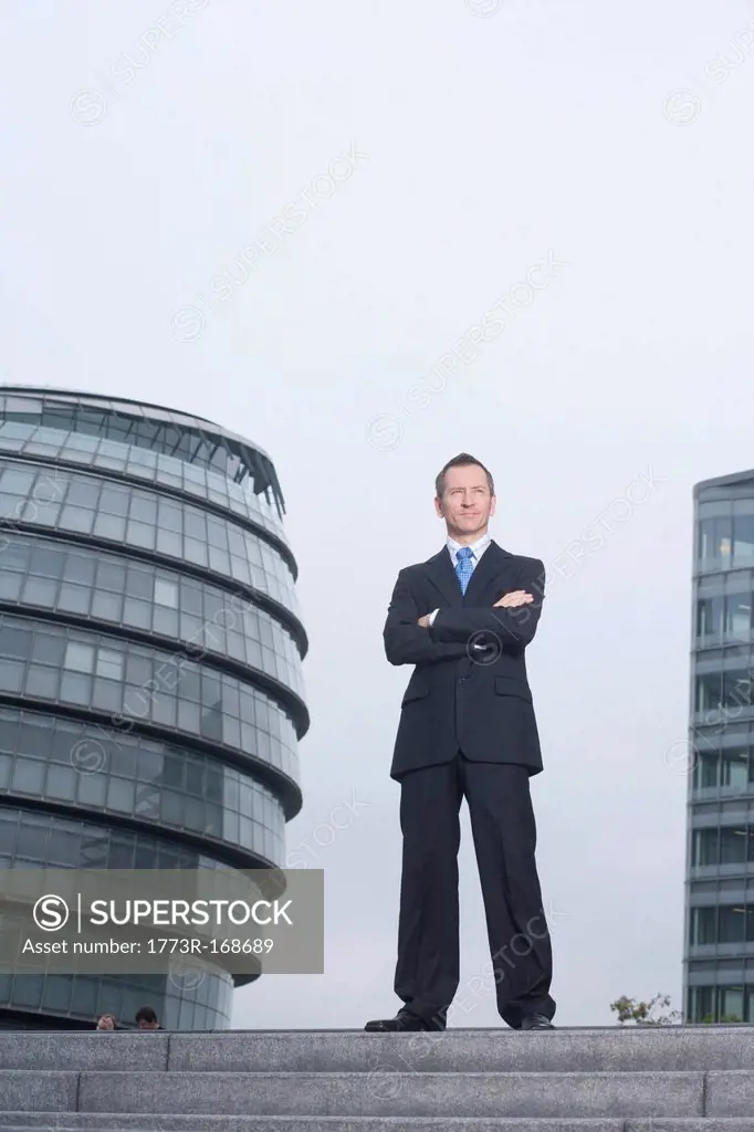 Businessman standing on urban steps
