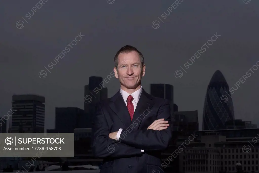 Businessman standing on urban rooftop