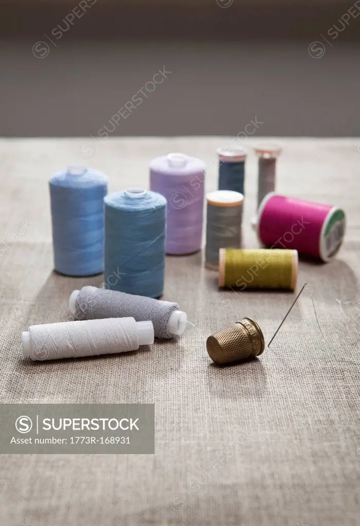 Thread, sewing needle and thimble