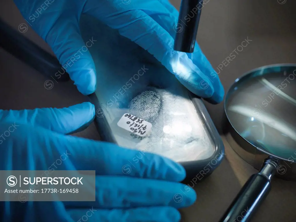 Forensic scientist examining fingerprint