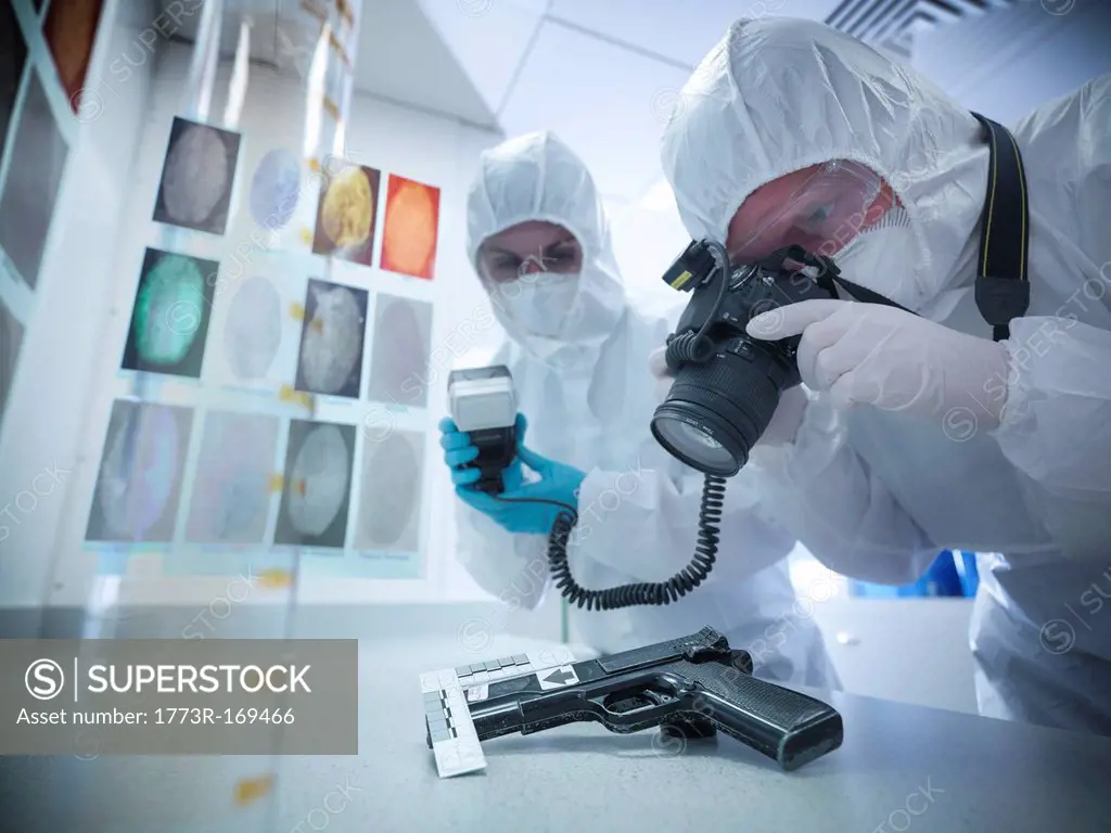 Forensic scientists examining gun