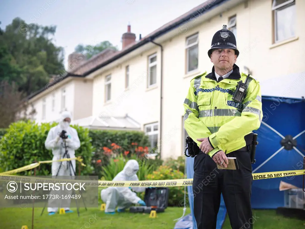 Policeman guarding forensic crime scene