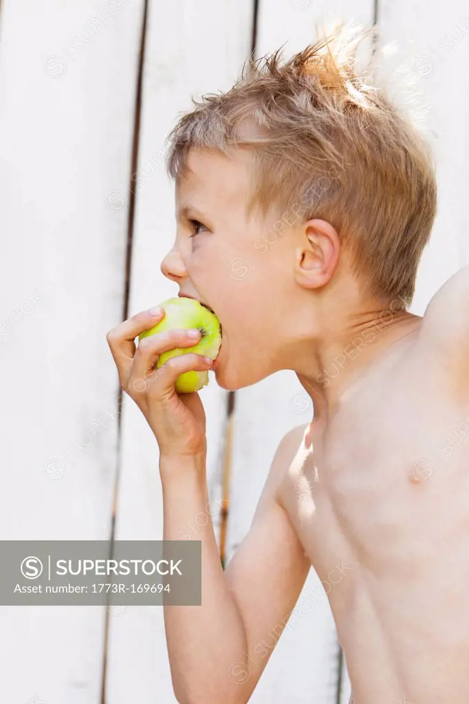 Close up of boy eating apple