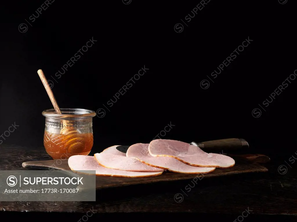 Jar of honey with plate of ham