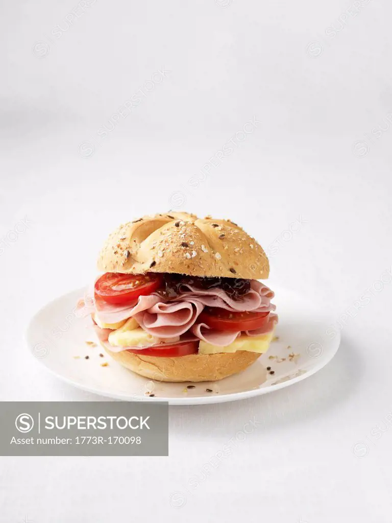 Ham and tomato sandwich on plate