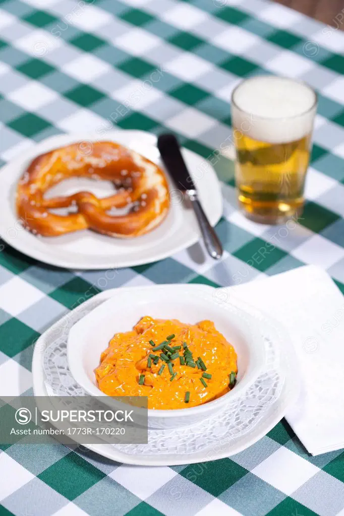 Cheese soup with beer and pretzel