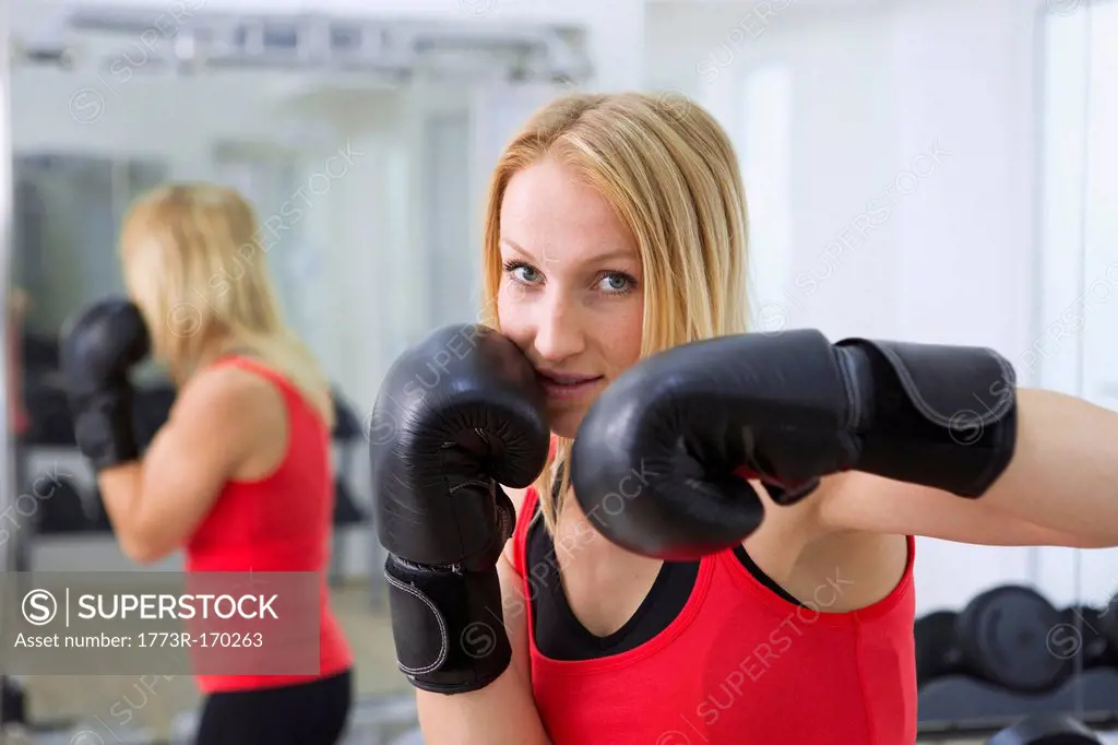 Boxer training with gloves in gym