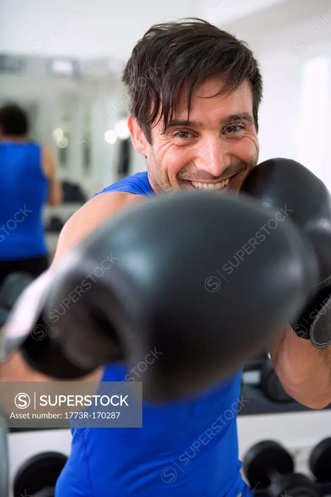 Boxer wearing boxing gloves in gym