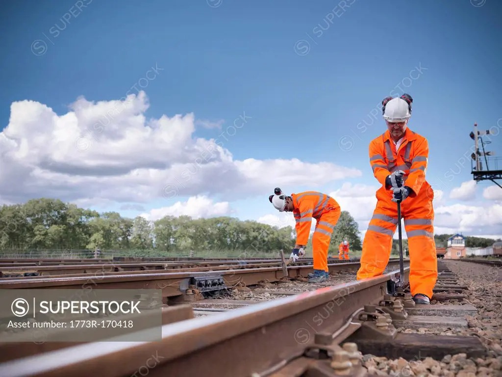 Railway workers adjusting train tracks