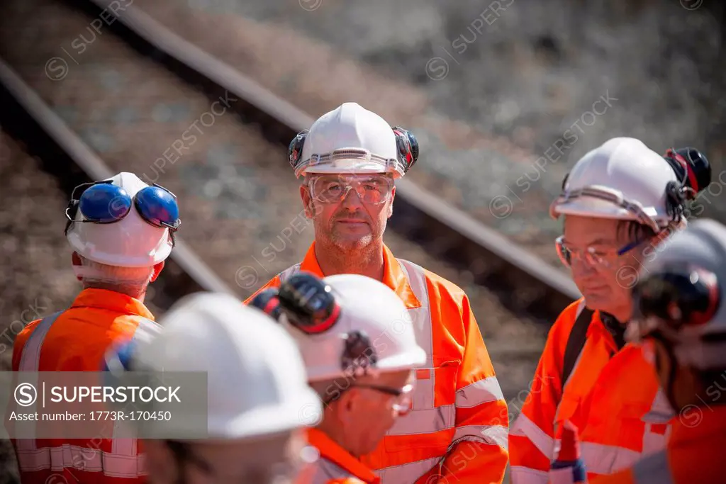 Railway workers talking outdoors